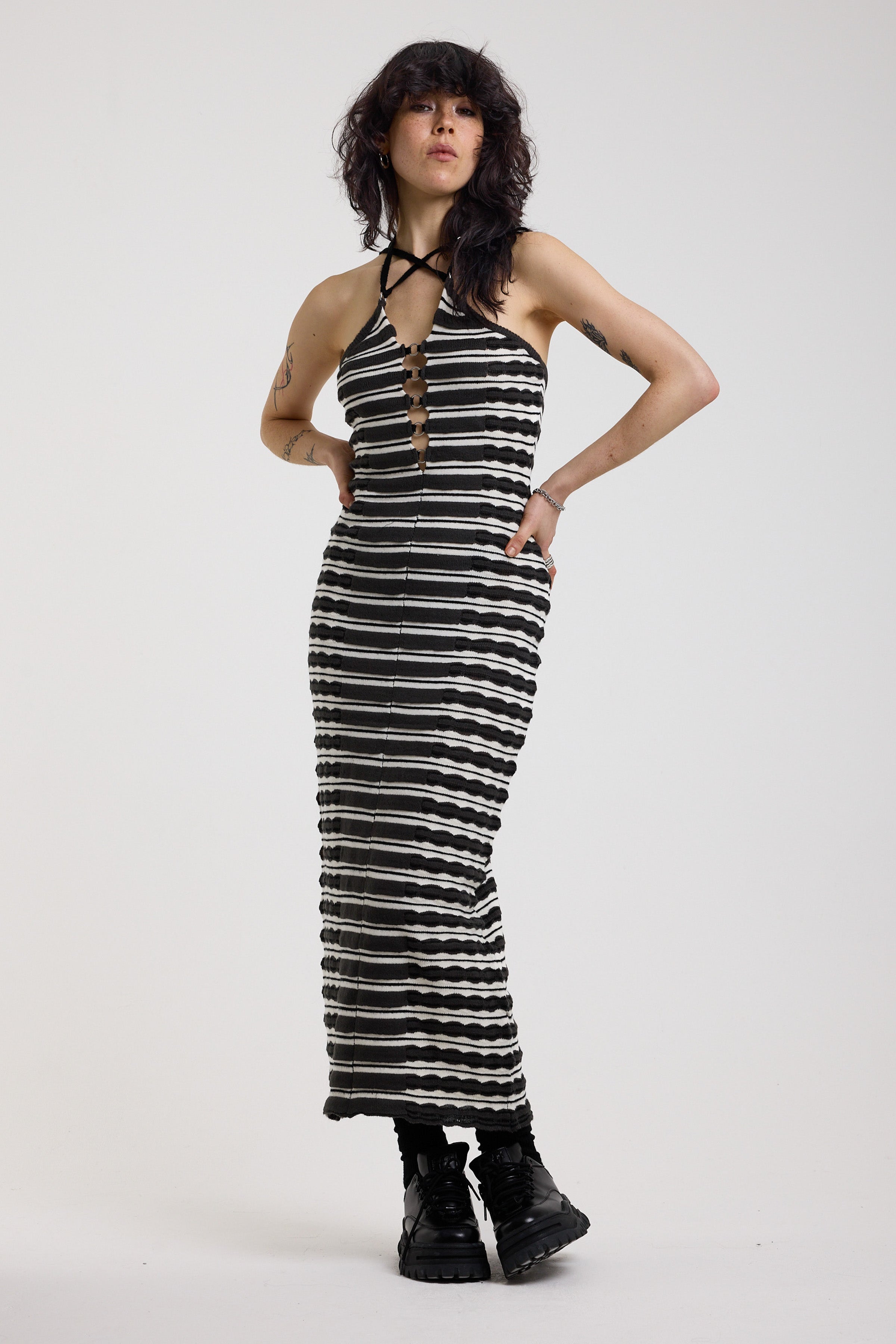 Black and grey textured stripe knit maxi dress with cut out front and silver hardware, worn by model
