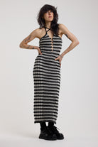 Black and grey textured stripe knit maxi dress with cut out front and silver hardware, worn by model