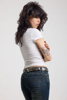 Back view of white shrunken baby t-shirt with spiked lamb graphic print, worn by a model