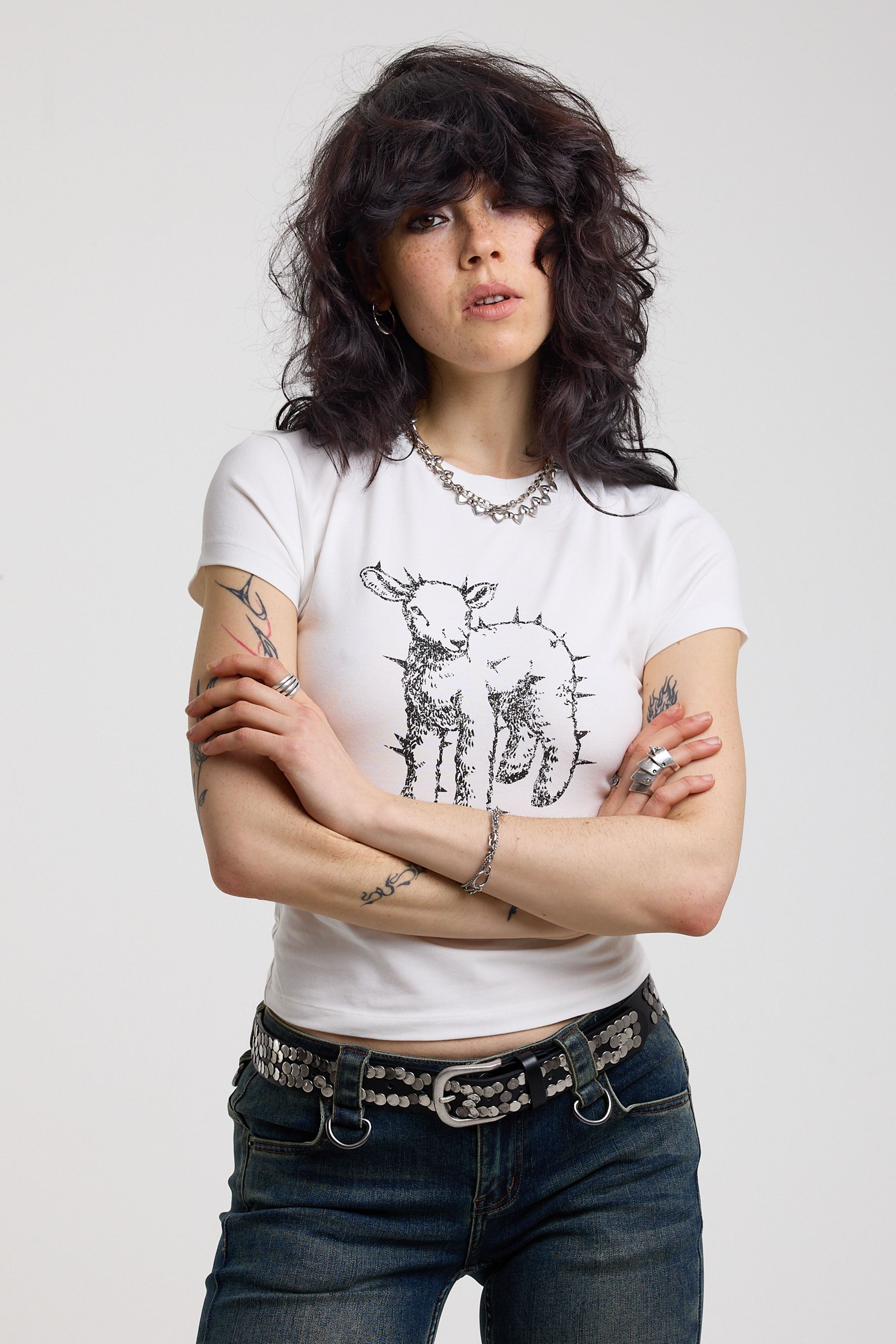 White shrunken baby t-shirt with spiked lamb graphic print, worn by a model