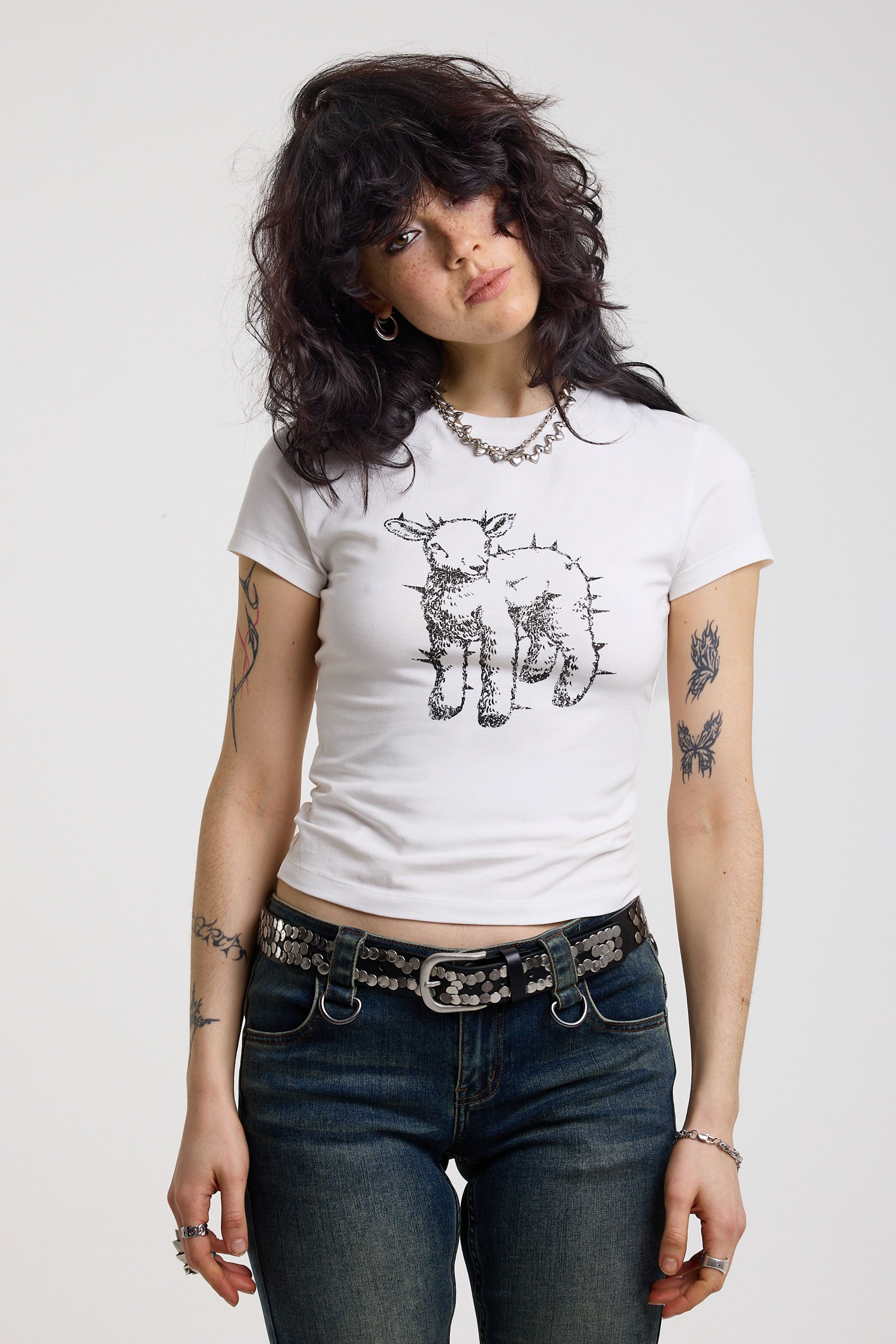 White shrunken baby t-shirt with spiked lamb graphic print, worn by a model
