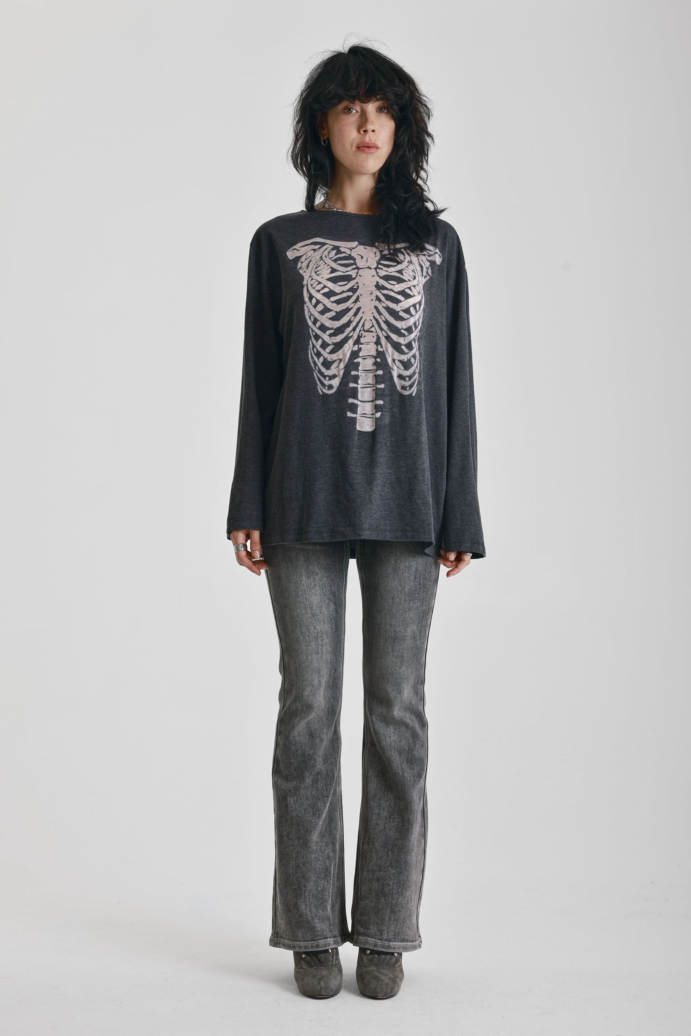 Washed black slouchy fit long sleeve t-shirt with skeleton ribcage burnout graphic, worn by model