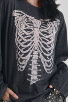 Washed black slouchy fit long sleeve t-shirt with skeleton ribcage burnout graphic, worn by model