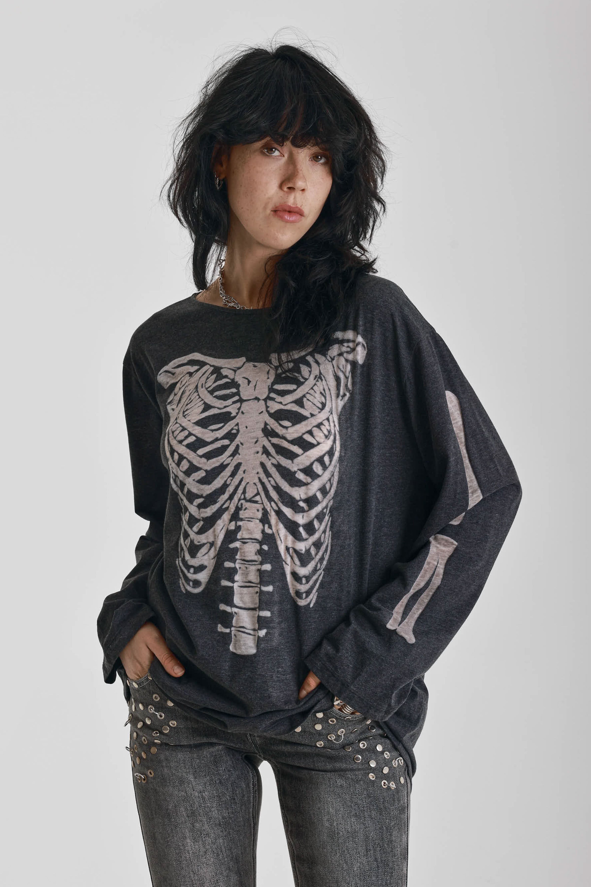 Washed black slouchy fit long sleeve t-shirt with skeleton ribcage burnout graphic, worn by model