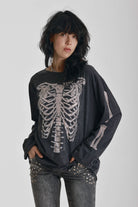 Washed black slouchy fit long sleeve t-shirt with skeleton ribcage burnout graphic, worn by model