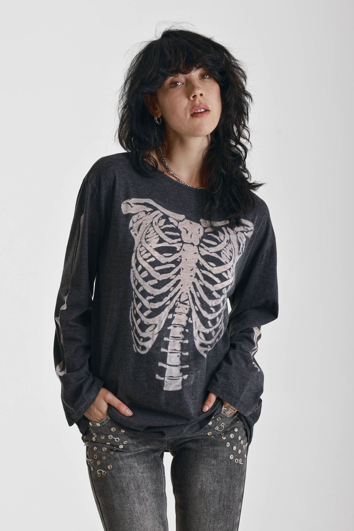 Washed black slouchy fit long sleeve t-shirt with skeleton ribcage burnout graphic, worn by model