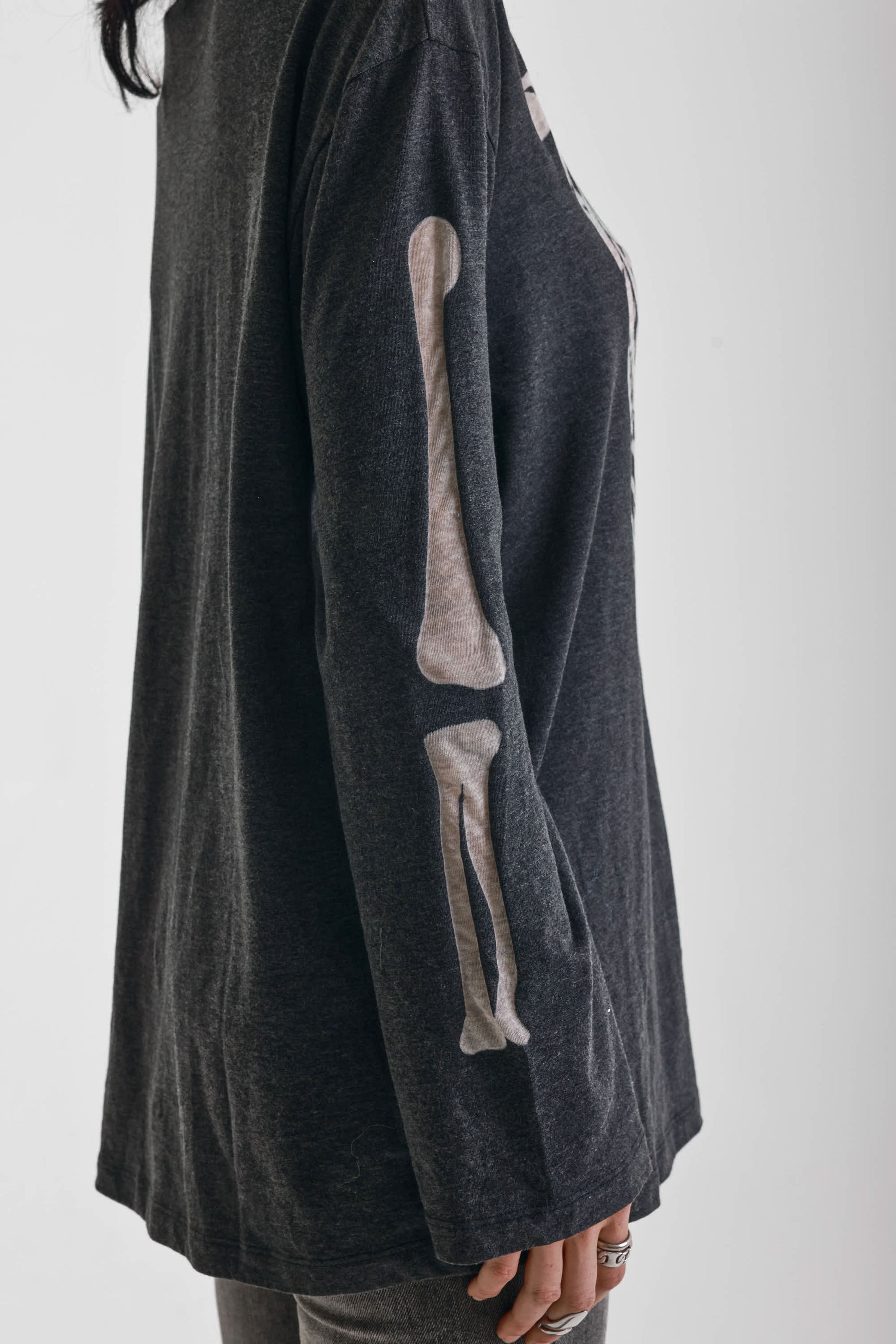 Washed black slouchy fit long sleeve t-shirt with skeleton ribcage burnout graphic, worn by model