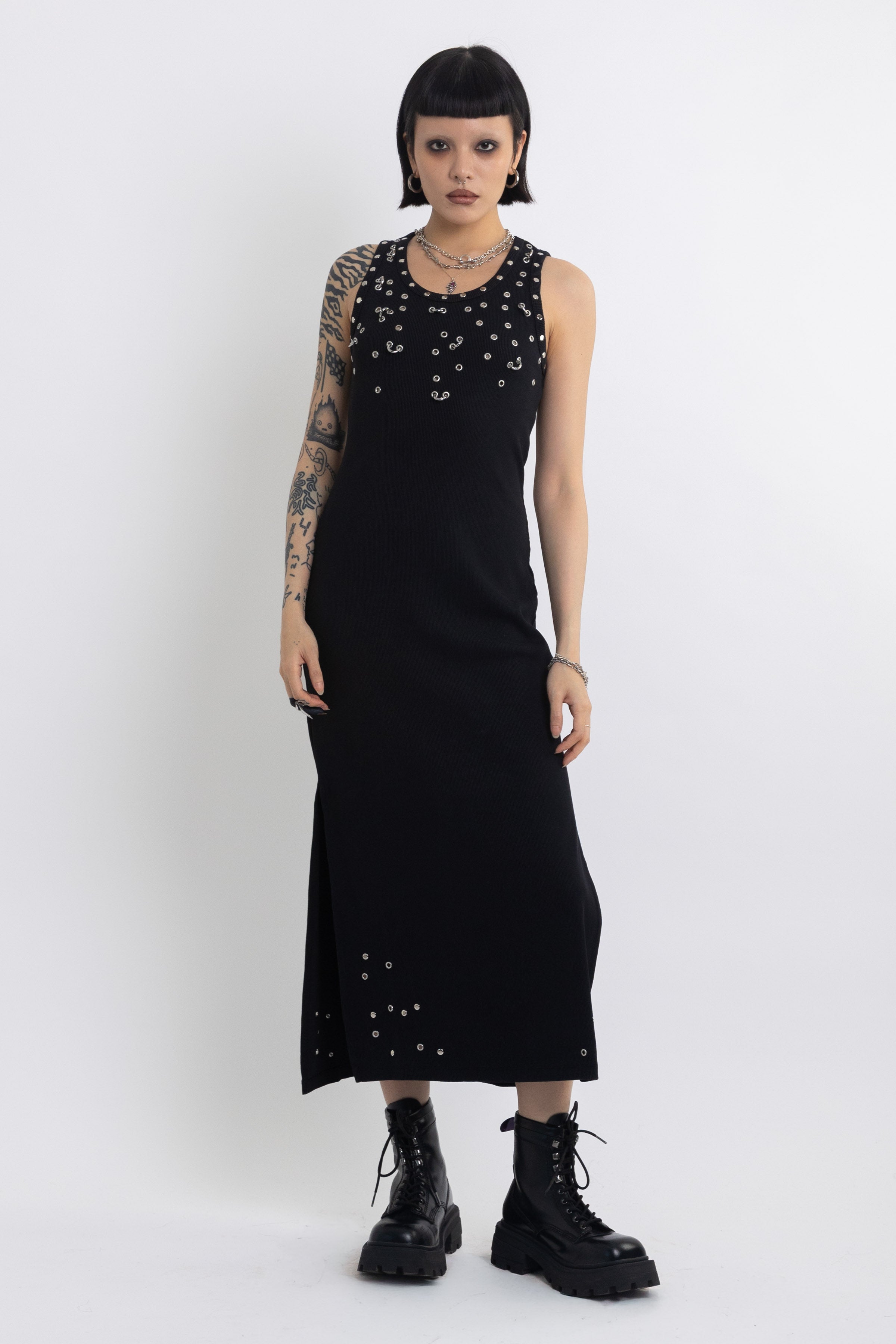 Black midi dress with silver eyelet and piercing hardware,worn by model