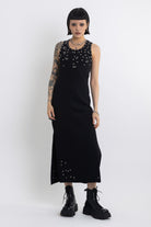Black midi dress with silver eyelet and piercing hardware,worn by model