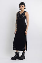 Black midi dress with silver eyelet and piercing hardware,worn by model