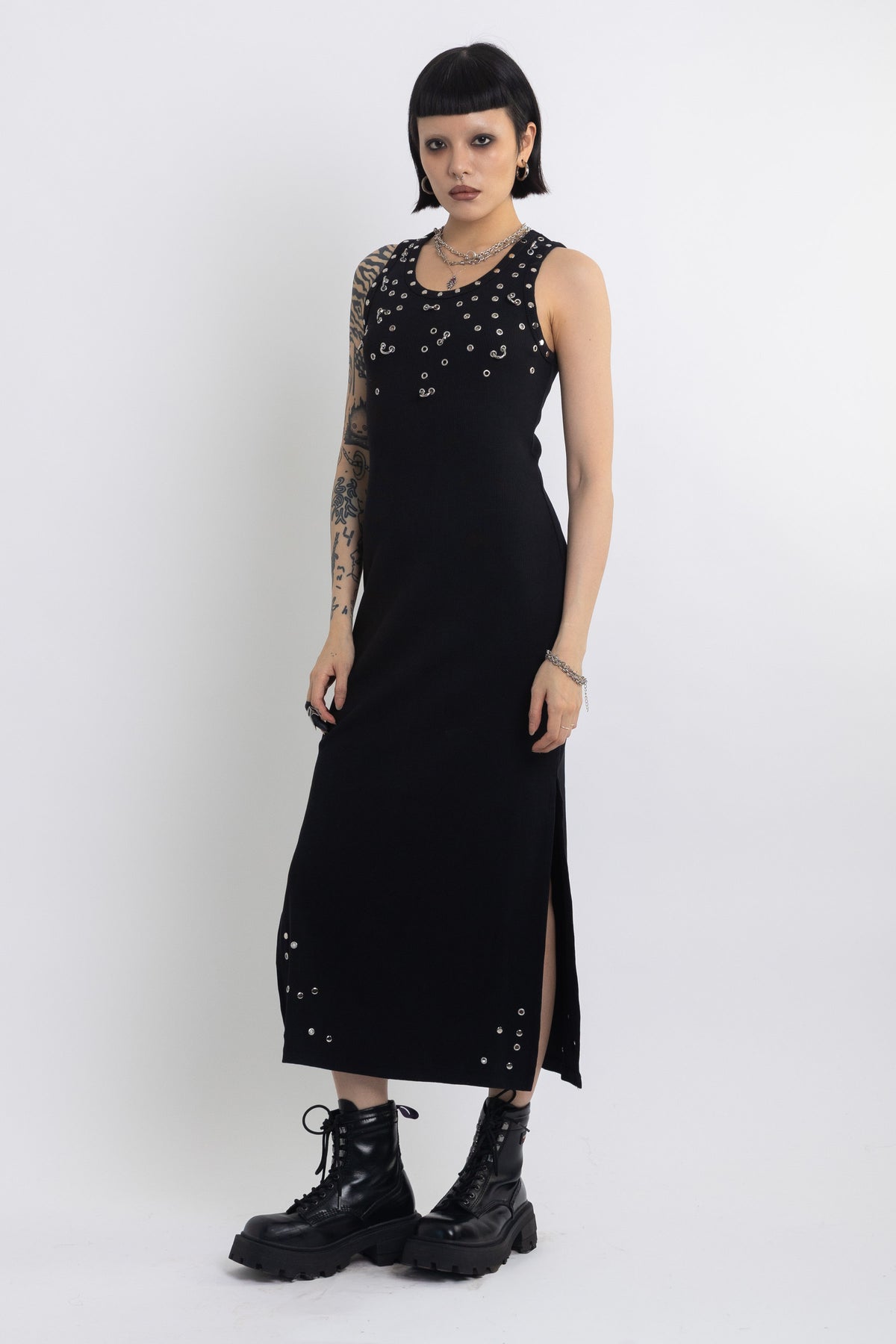 Black midi dress with silver eyelet and piercing hardware,worn by model