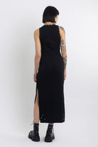 Black midi dress with silver eyelet and piercing hardware,worn by model