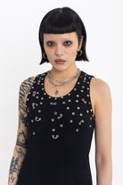 Black midi dress with silver eyelet and piercing hardware,worn by model