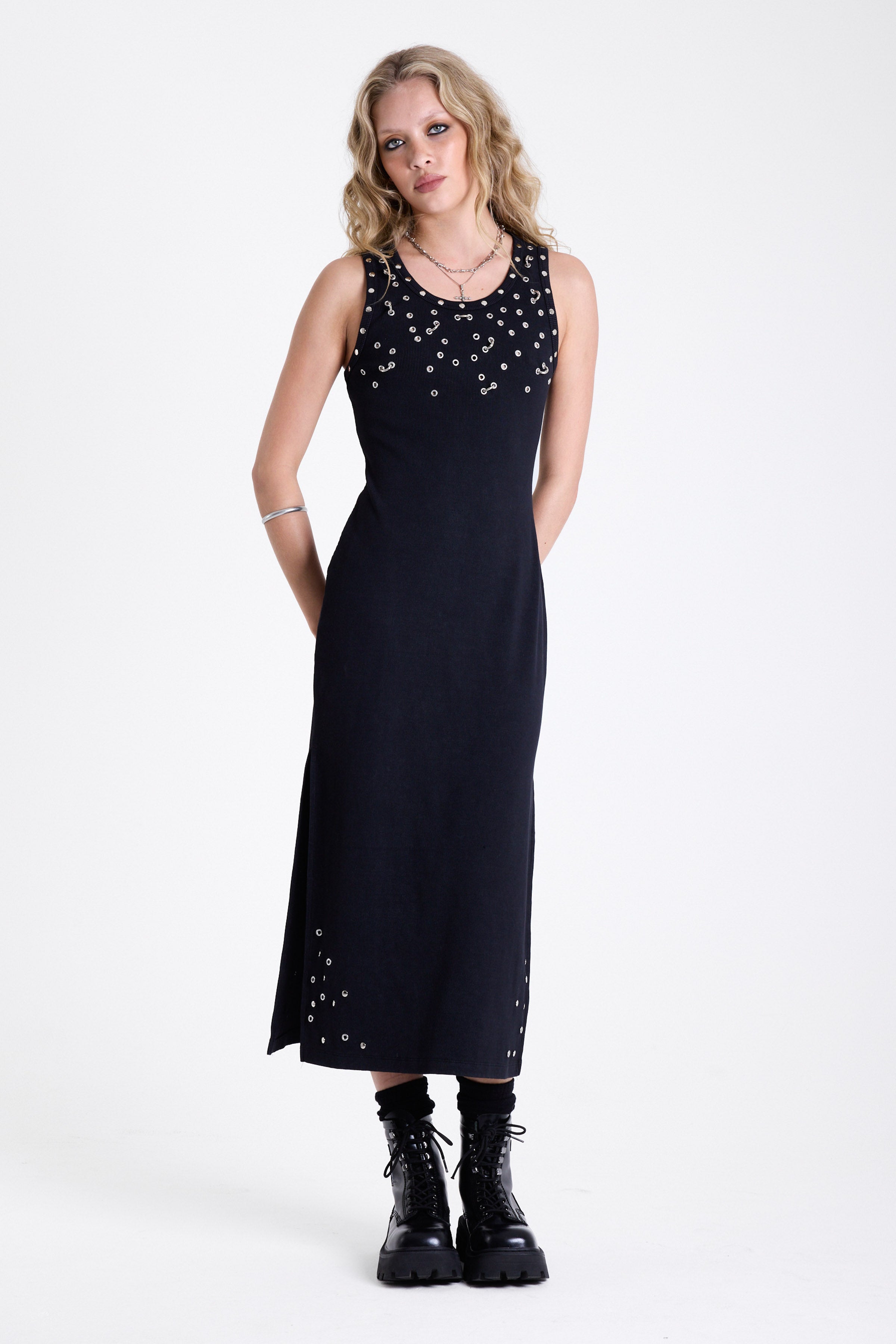 Black bodycon maxi dress with silver stud and piercing detail, worn by model