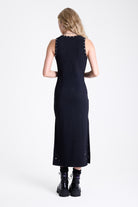 Black bodycon maxi dress with silver stud and piercing detail, worn by model