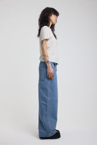 Side view of blue gingham checked baggy wide leg release jeans, worn by model