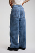 Back view of blue gingham checked baggy wide leg release jeans, worn by model