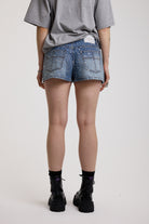 Light wash denim hotpants with all over hot fix silver studs, worn by model