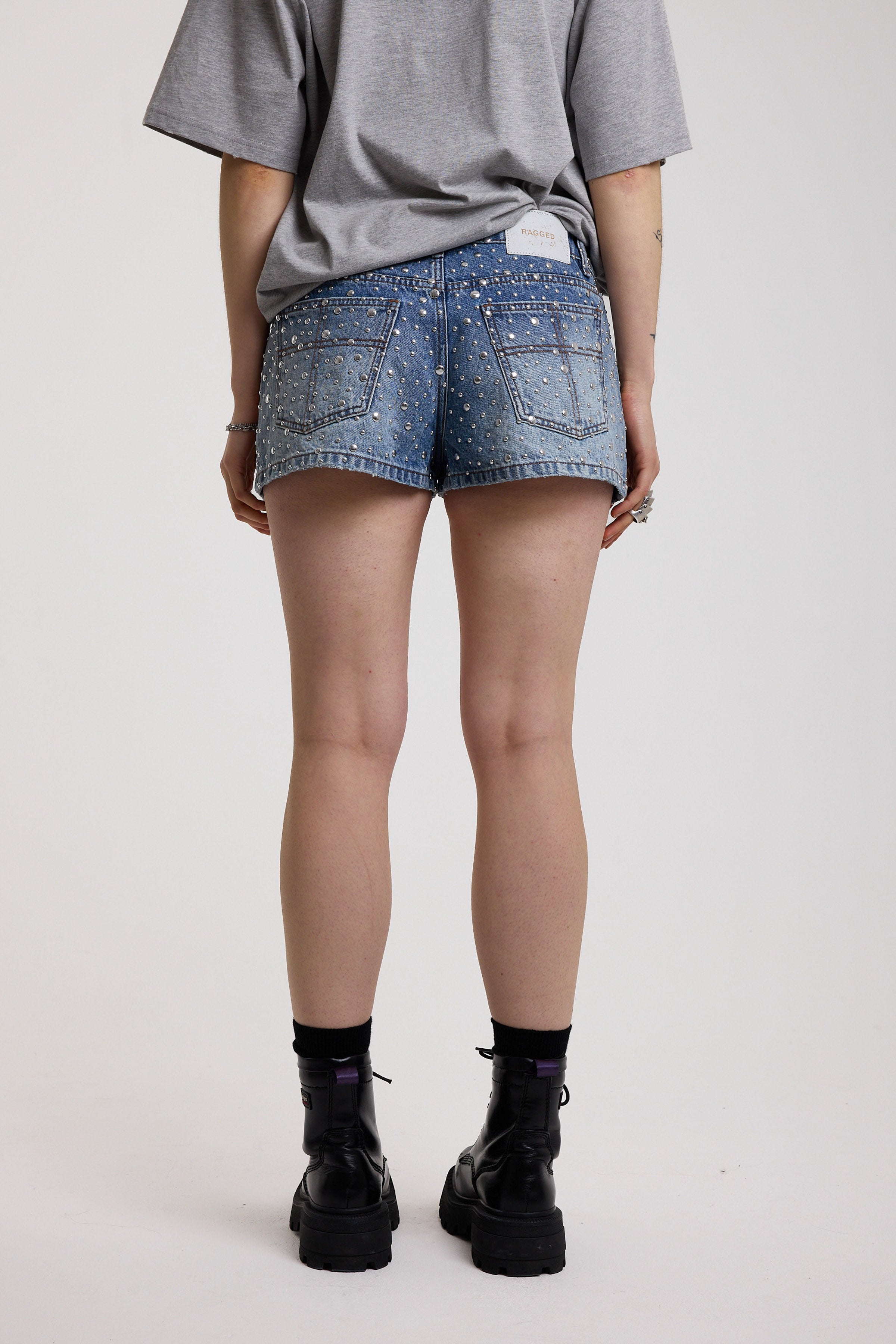 Light wash denim hotpants with all over hot fix silver studs, worn by model
