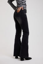 Back image of Washed black flare bootcut jeans with eyelet cut out detail, worn by model