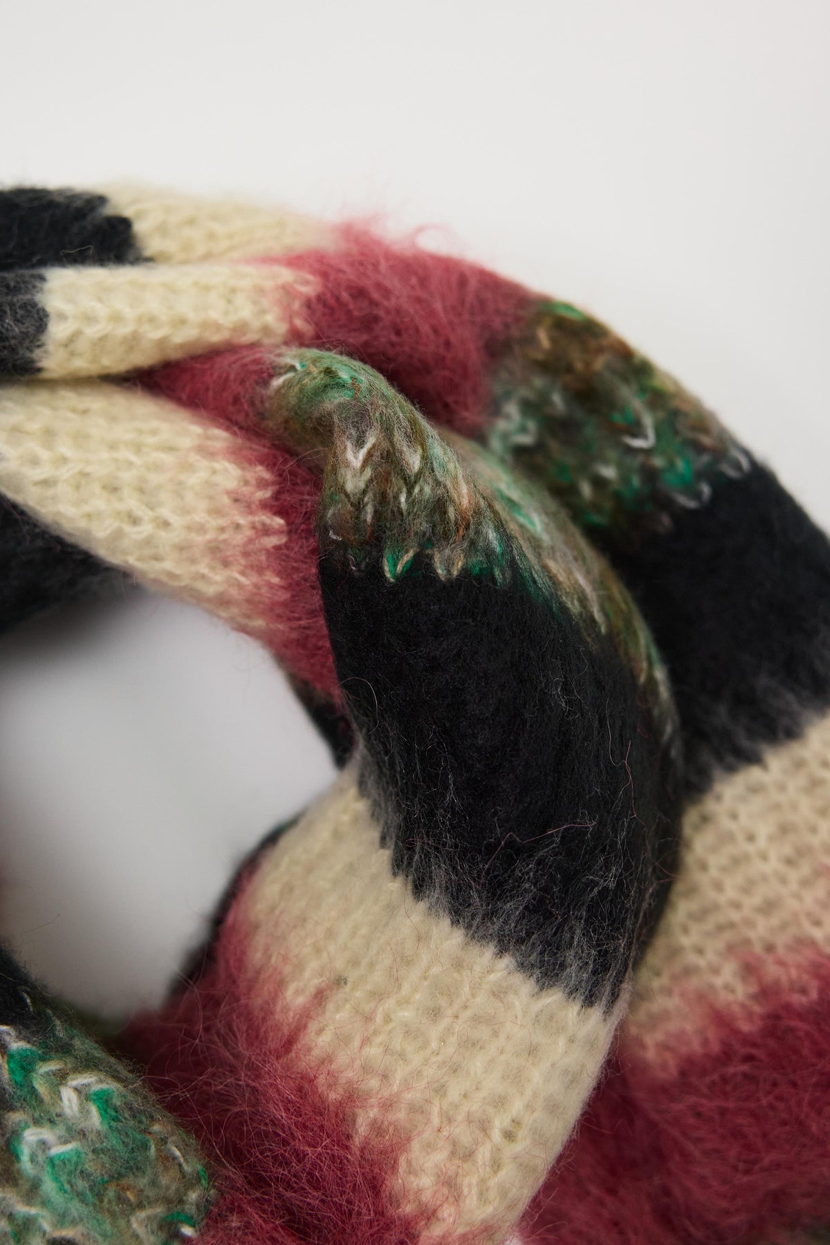 Mixed black, cream, pink and green stripe textured knit oversized blanket scarf, worn by model.