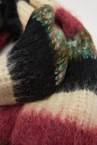 Mixed black, cream, pink and green stripe textured knit oversized blanket scarf, worn by model.