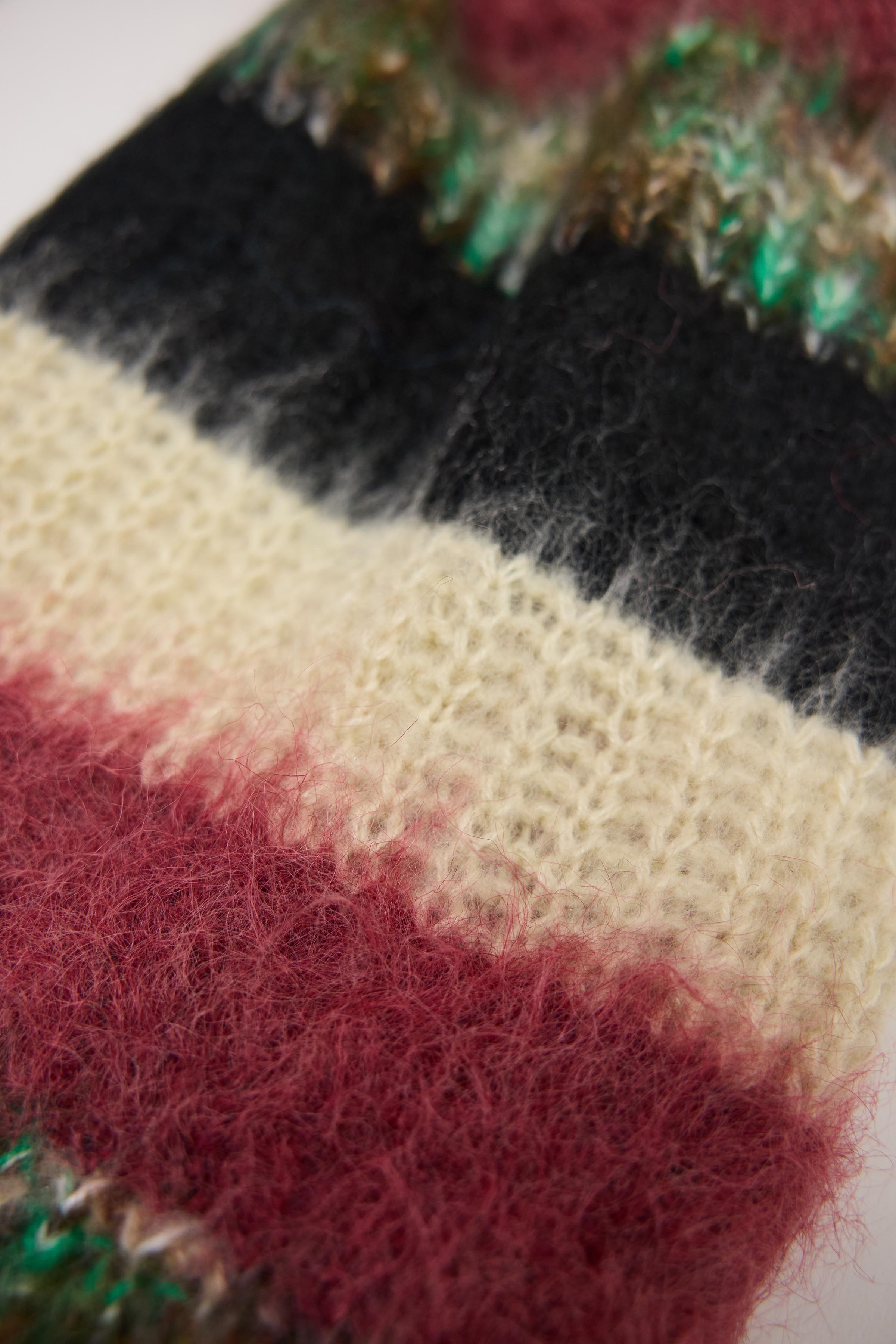 Mixed black, cream, pink and green stripe textured knit oversized blanket scarf, worn by model.
