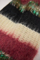 Mixed black, cream, pink and green stripe textured knit oversized blanket scarf, worn by model.