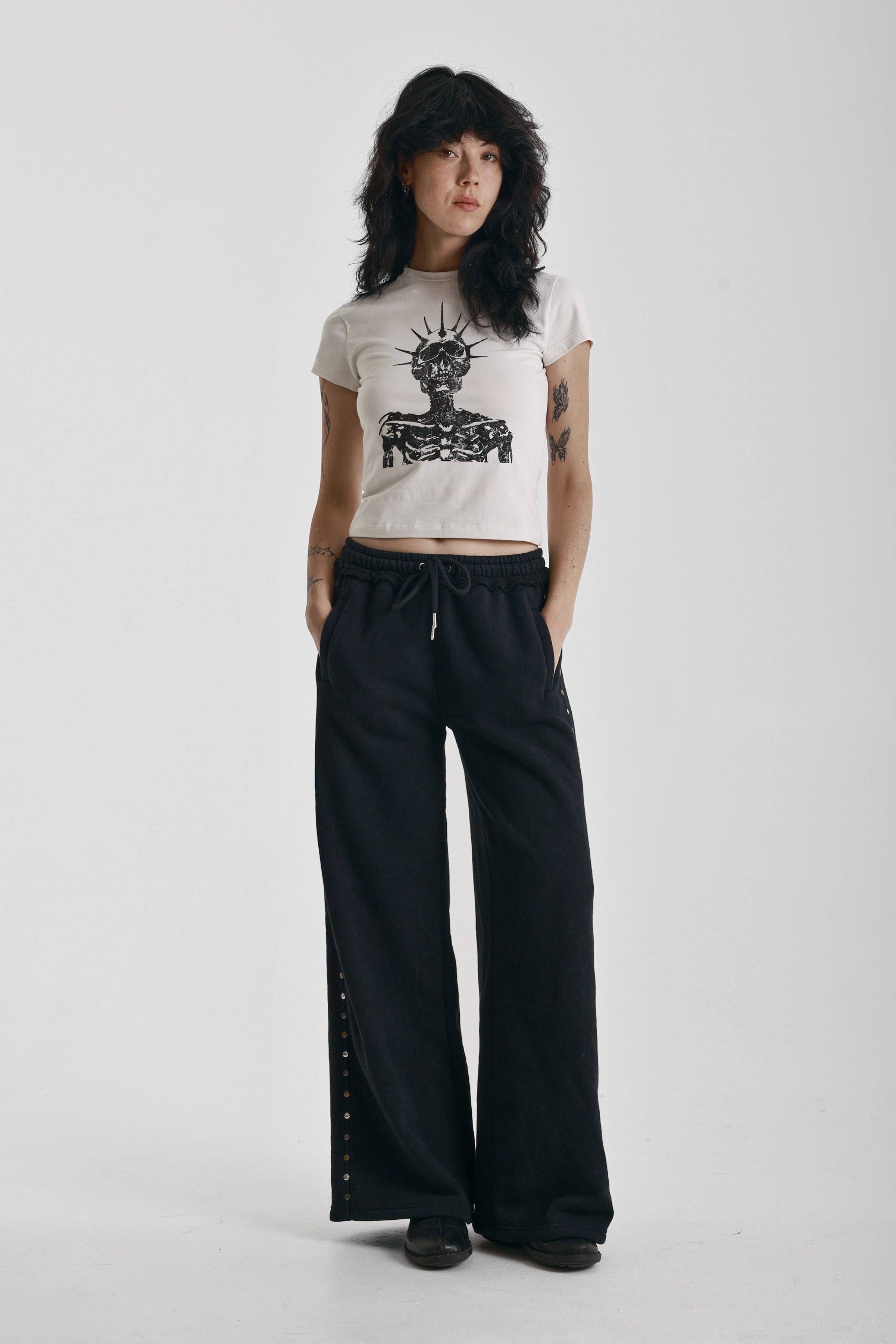 Washed black wide leg sweatpants with mixed metal studs, worn by model
