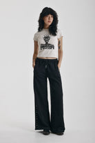 Washed black wide leg sweatpants with mixed metal studs, worn by model