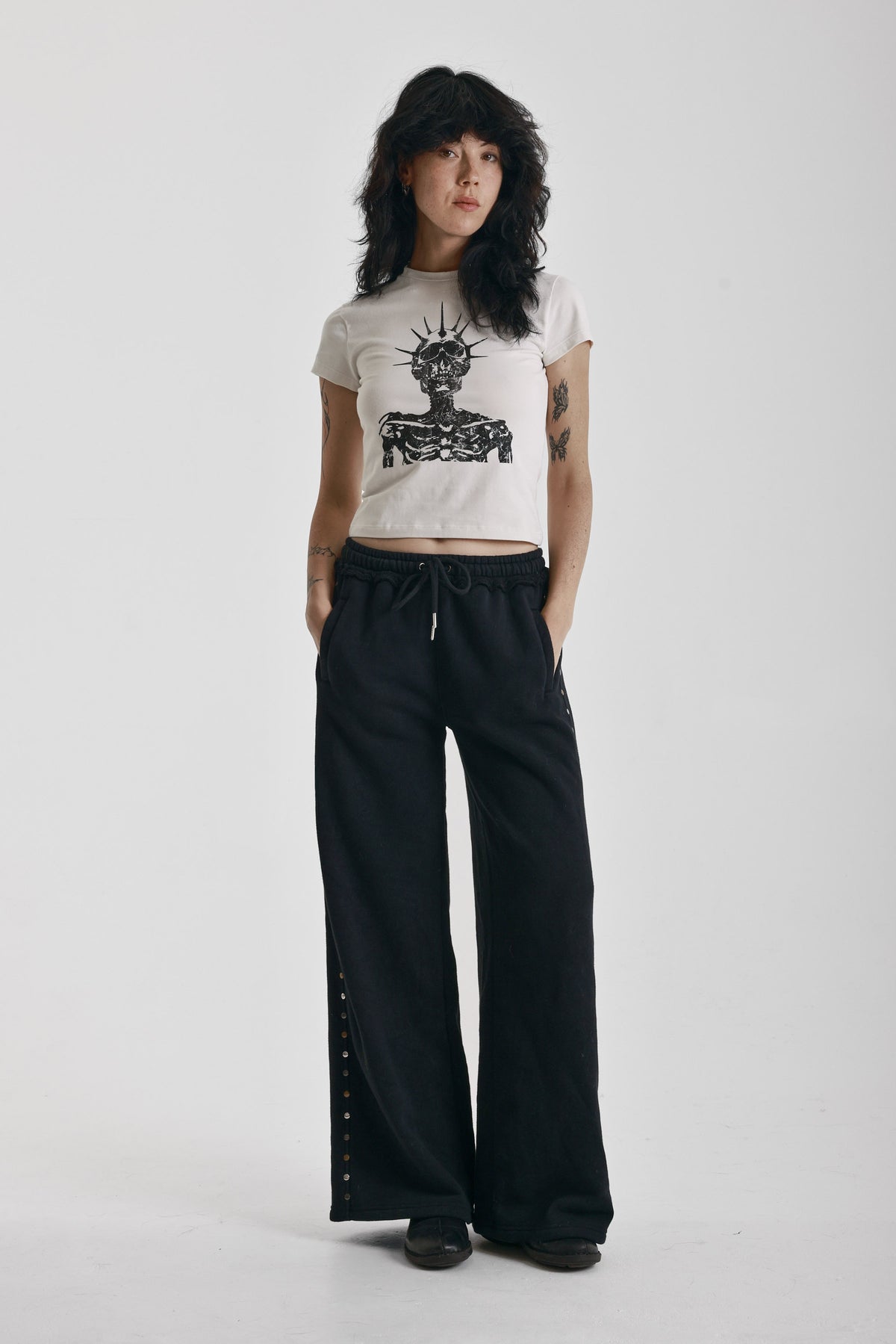 Washed black wide leg sweatpants with mixed metal studs, worn by model