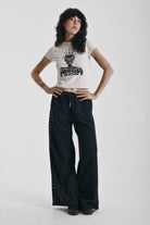 Washed black wide leg sweatpants with mixed metal studs, worn by model