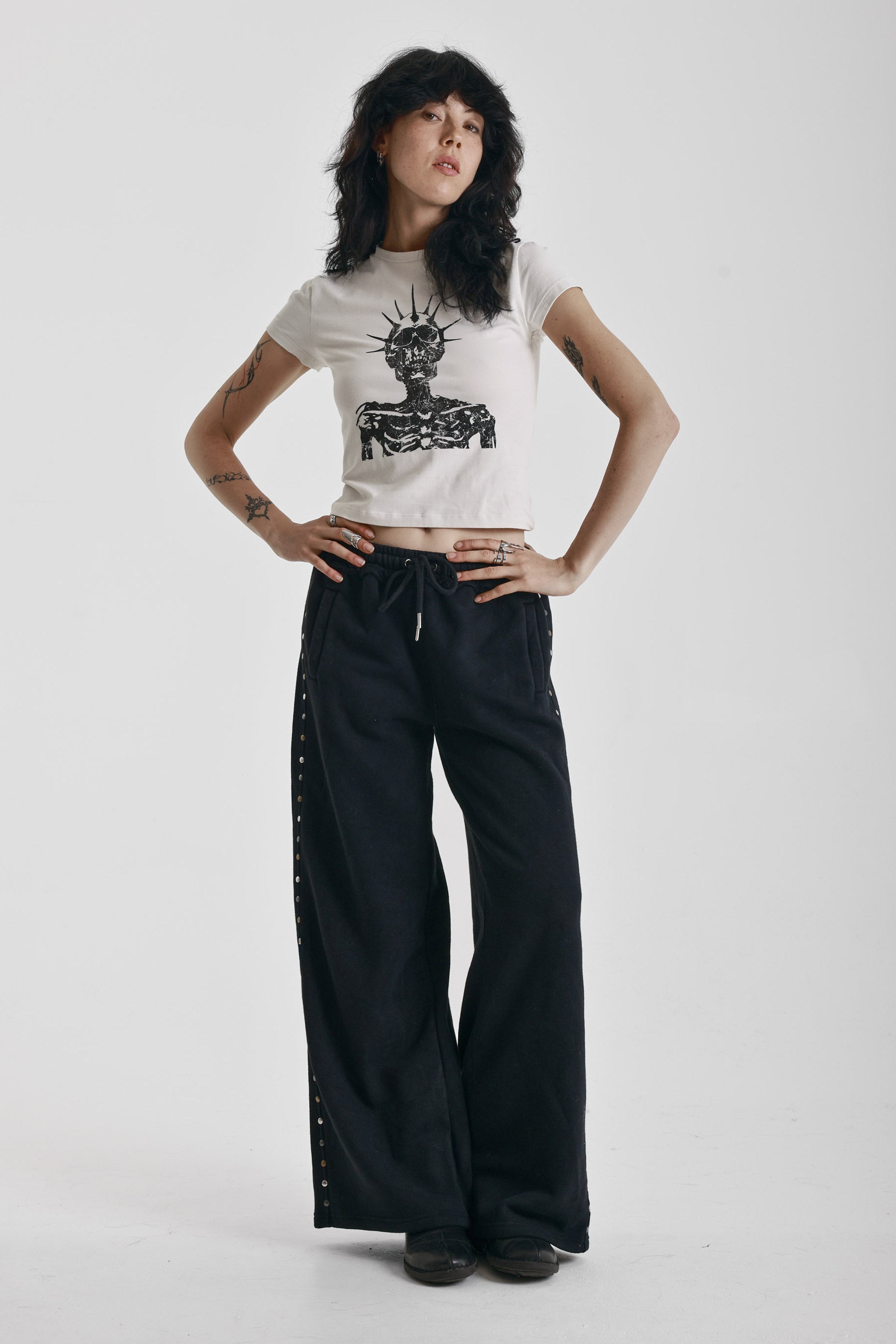 Washed black wide leg sweatpants with mixed metal studs, worn by model