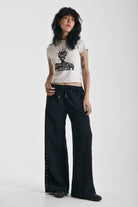 Washed black wide leg sweatpants with mixed metal studs, worn by model