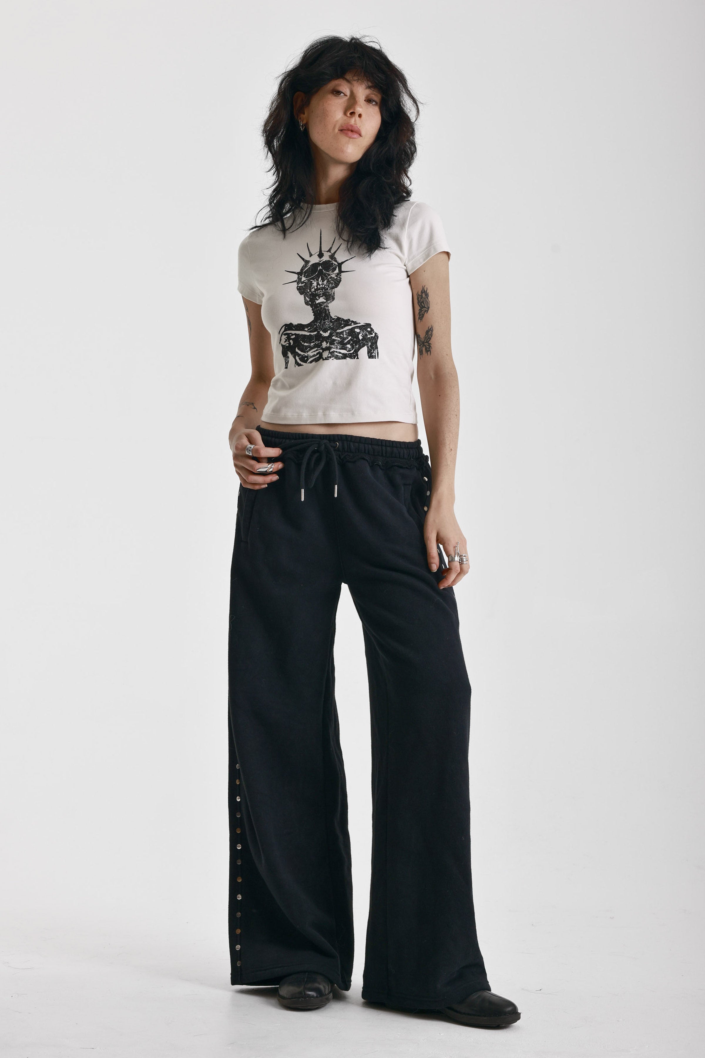 Washed black wide leg sweatpants with mixed metal studs, worn by model