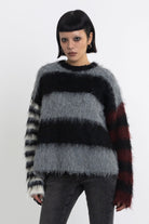 Black and grey colourblock stripe fuzzy knit jumper with contrasting stripe sleeves, worn by model