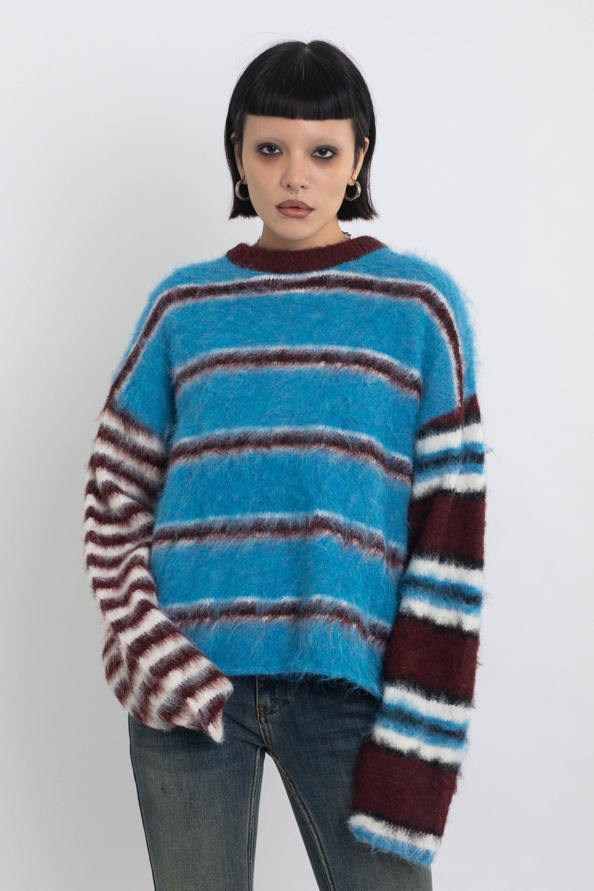 Blue and burgundy stripe fuzzy knit jumper, worn by model