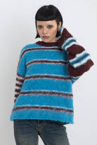 Blue and burgundy stripe fuzzy knit jumper, worn by model