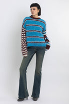 Blue and burgundy stripe fuzzy knit jumper, worn by model