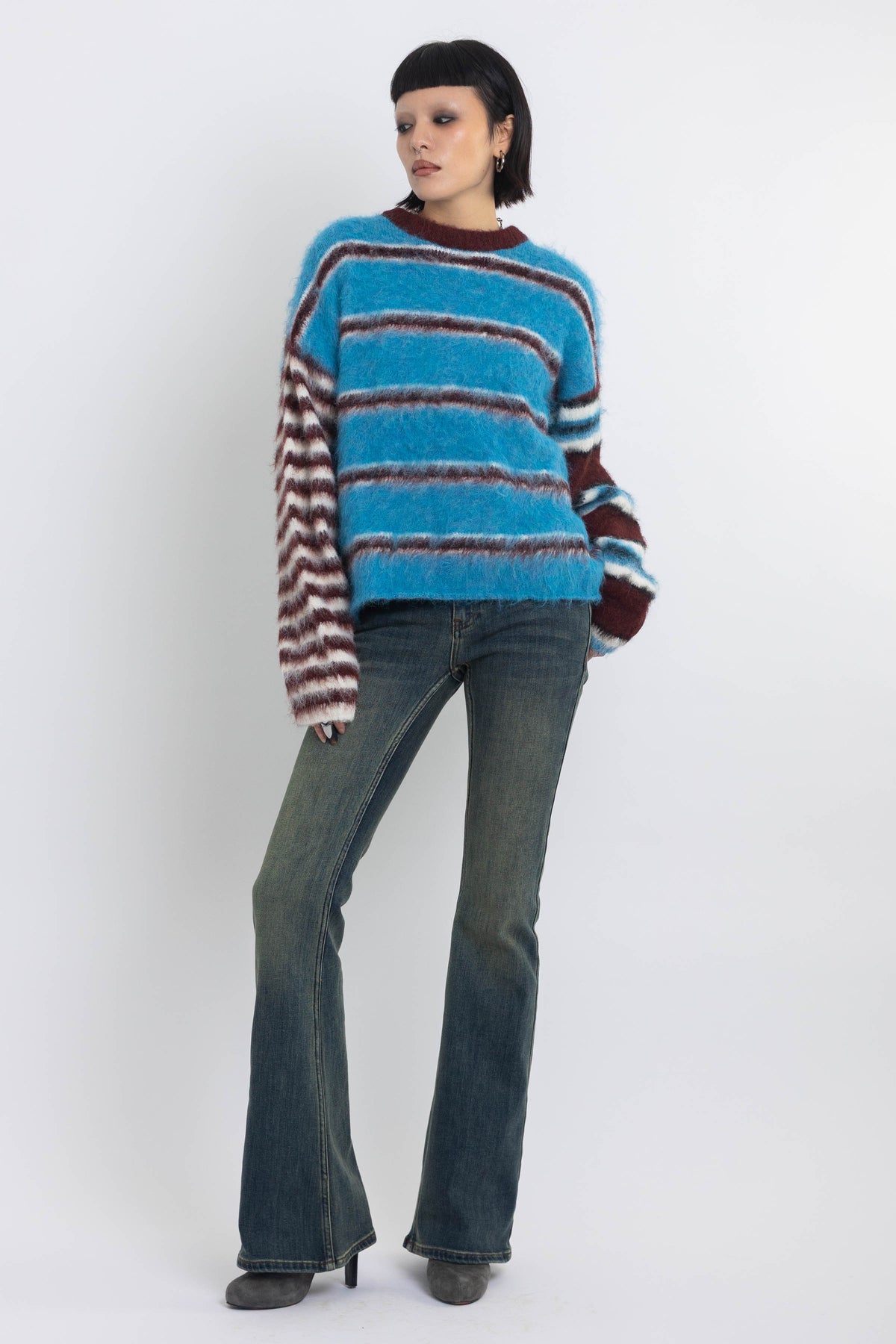 Blue and burgundy stripe fuzzy knit jumper, worn by model