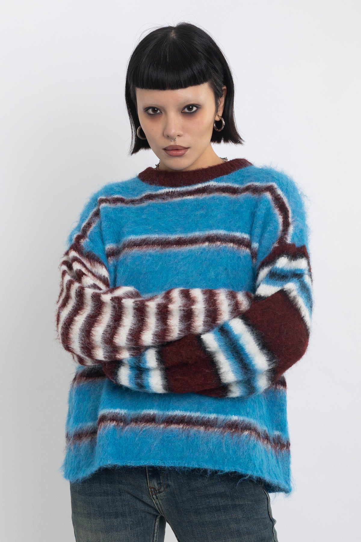 Blue and burgundy stripe fuzzy knit jumper, worn by model