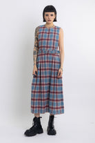 Sleeveless blue plaid check pinafore midi dress with eyelet hardware belt, worn by model
