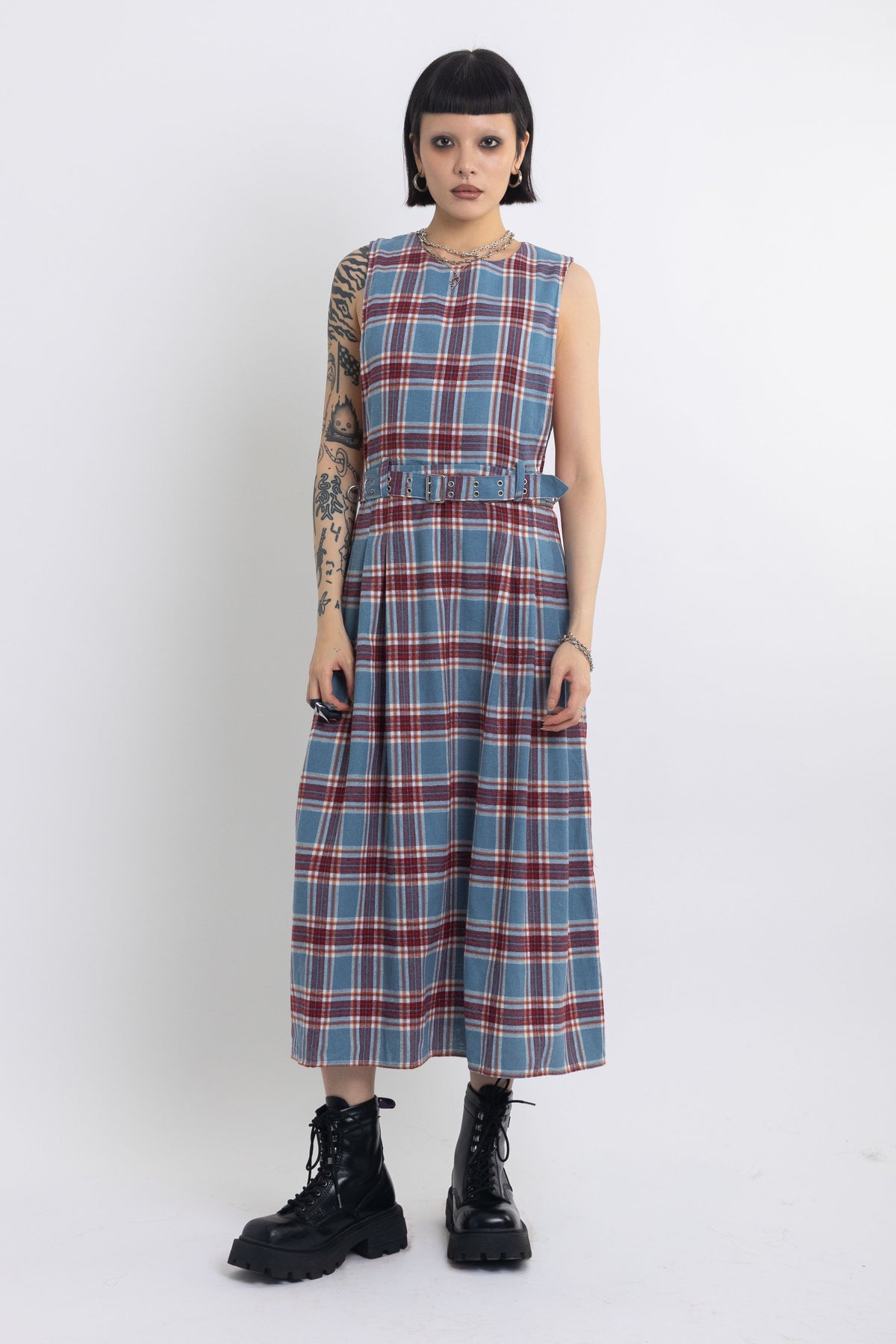 Sleeveless blue plaid check pinafore midi dress with eyelet hardware belt, worn by model