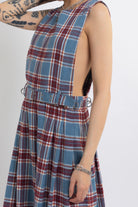 Sleeveless blue plaid check pinafore midi dress with eyelet hardware belt, worn by model