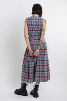 Sleeveless blue plaid check pinafore midi dress with eyelet hardware belt, worn by model