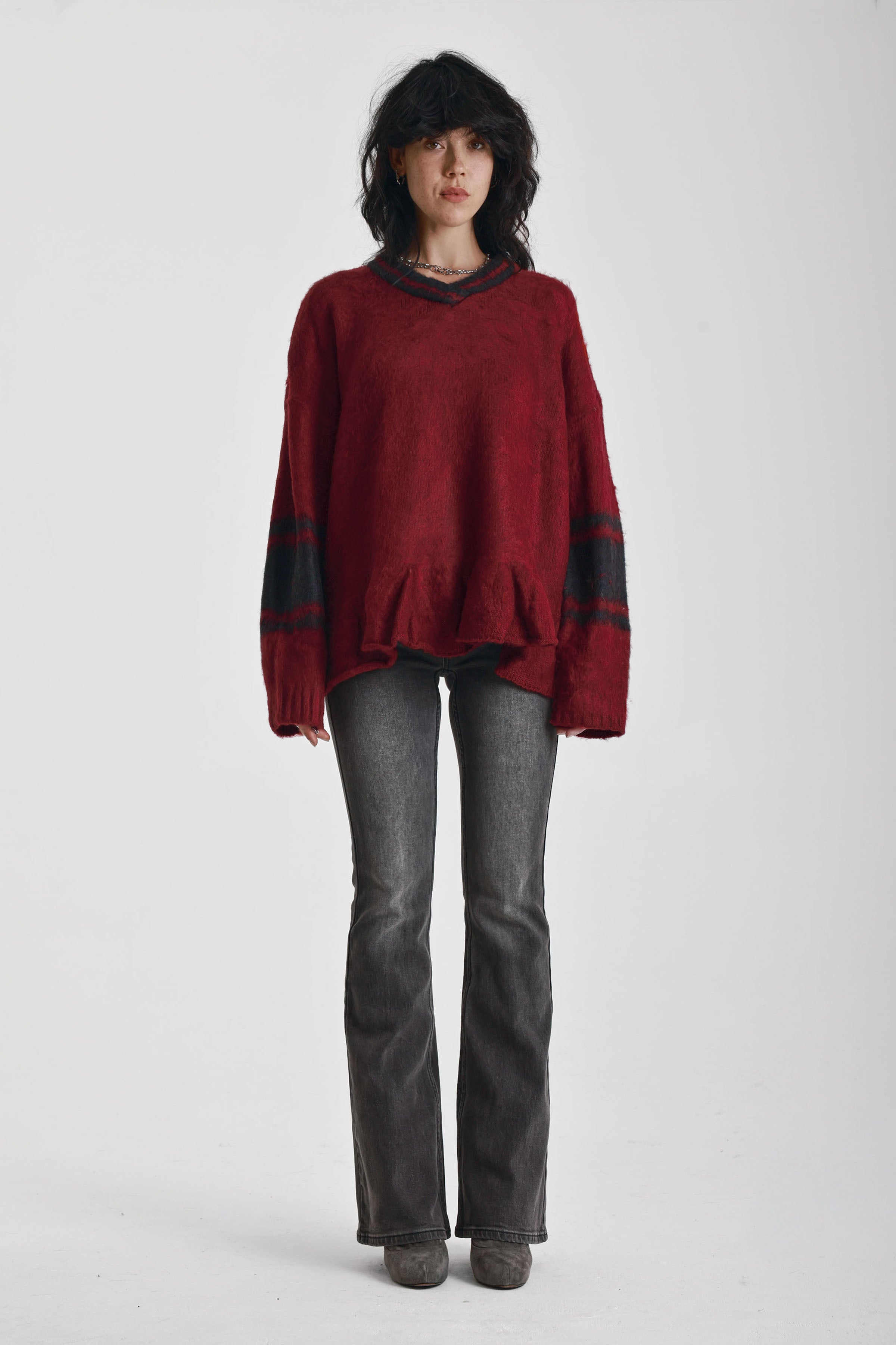 Red oversized v-neck knit jumper with varsity stripe detail and peplum hem, worn by model