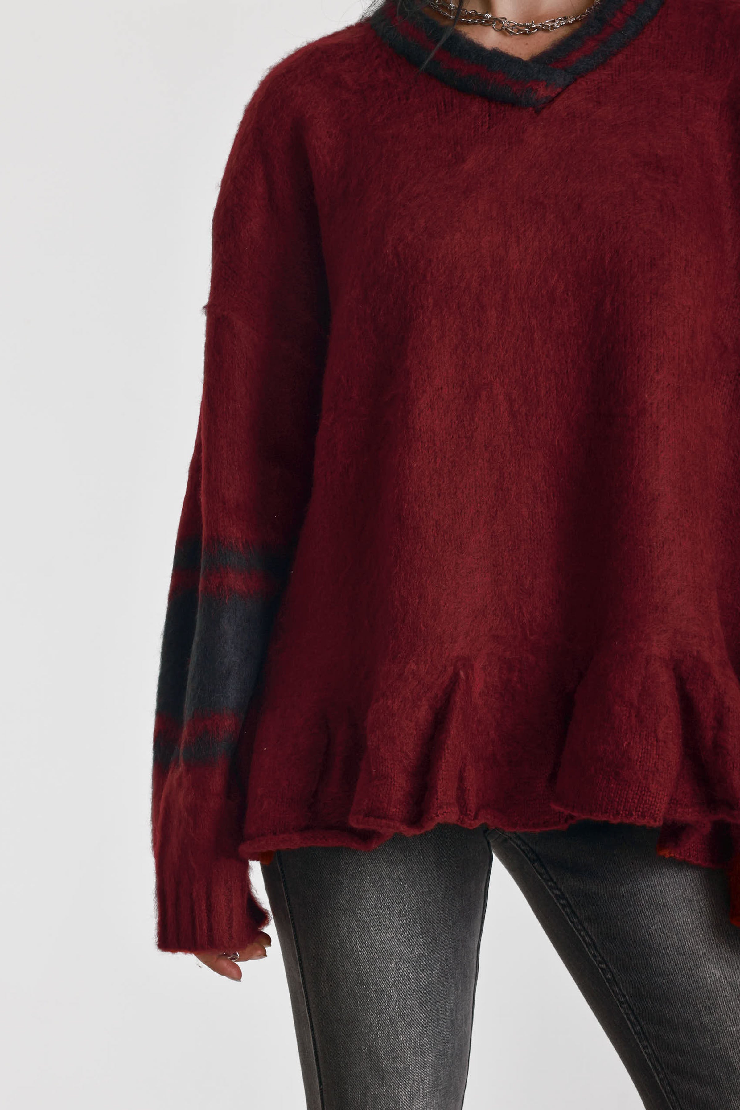 Red oversized v-neck knit jumper with varsity stripe detail and peplum hem, worn by model