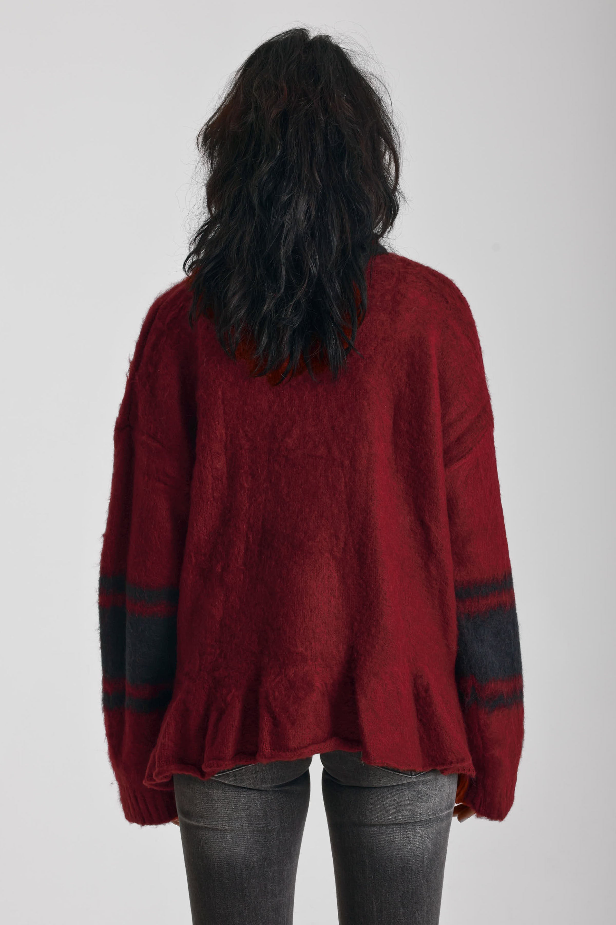 Red oversized v-neck knit jumper with varsity stripe detail and peplum hem, worn by model