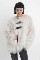 Ecru shaggy faux fur jacket with faux leather eyelet detail straps, worn by model