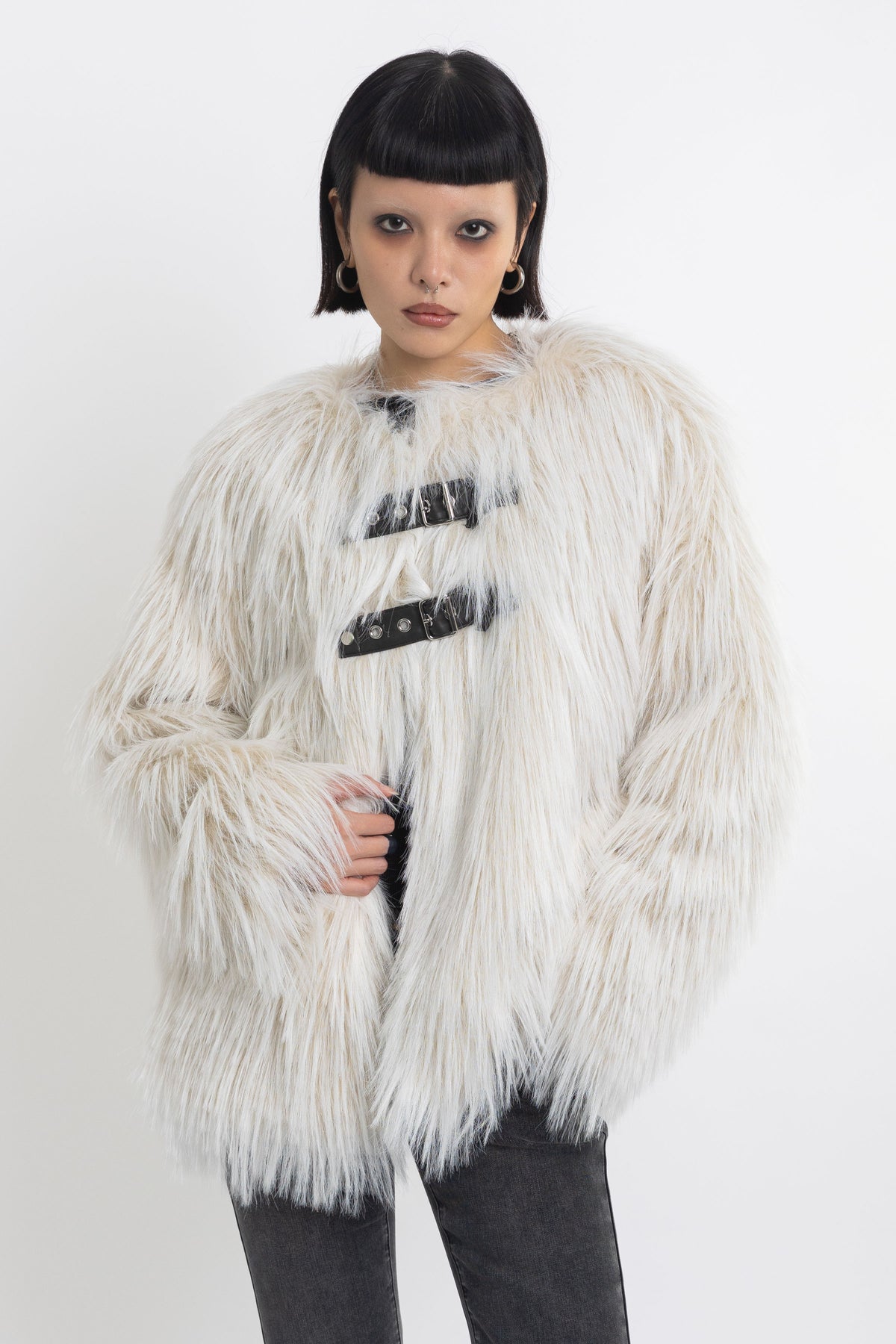 Ecru shaggy faux fur jacket with faux leather eyelet detail straps, worn by model